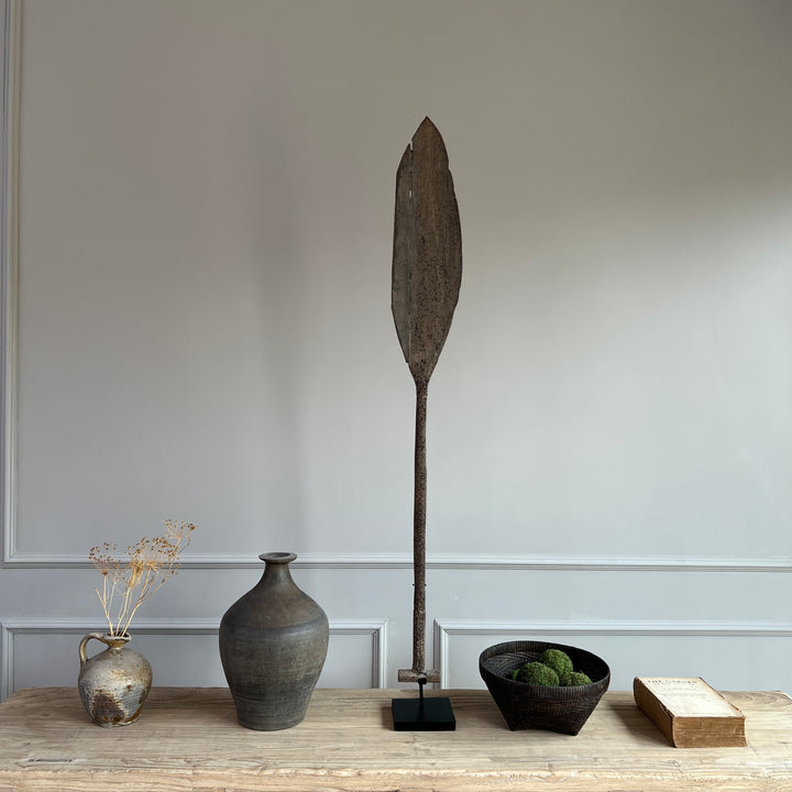 antique wooden paddle on stand