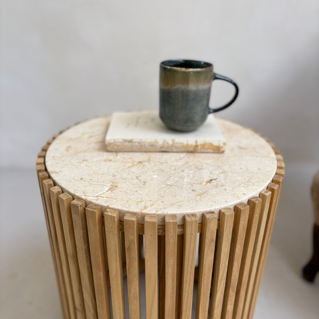 Slatted round marble topped side table close up