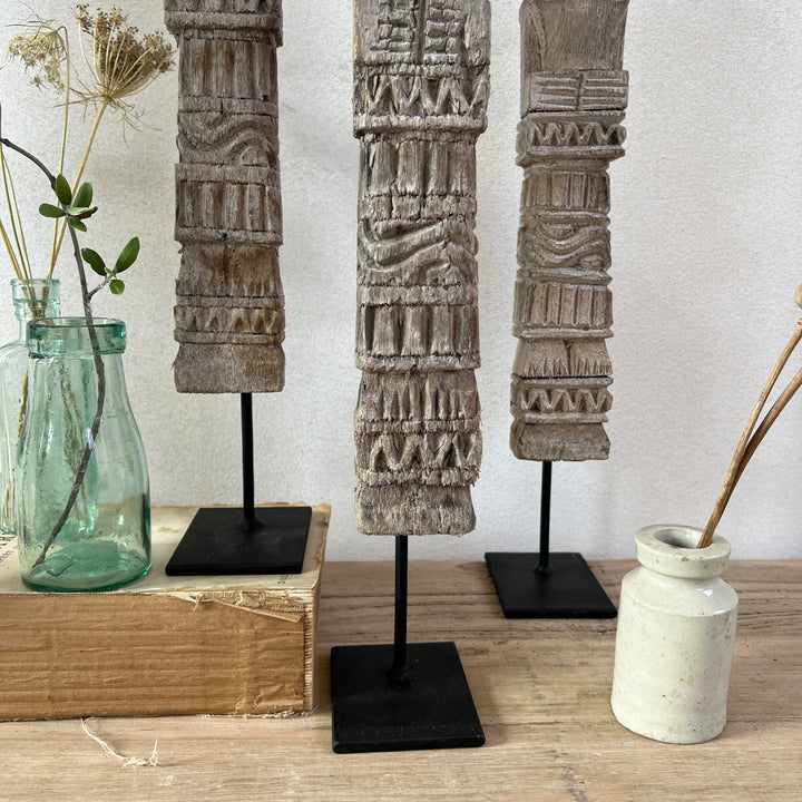 Vintage Balinese wooden statue on stand close up of stand