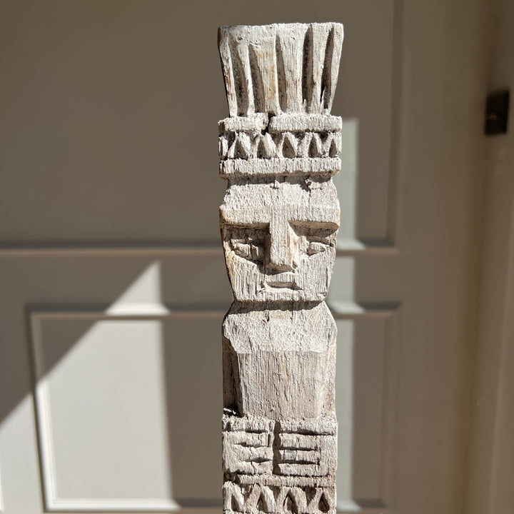 Vintage Balinese wooden statue on stand close up