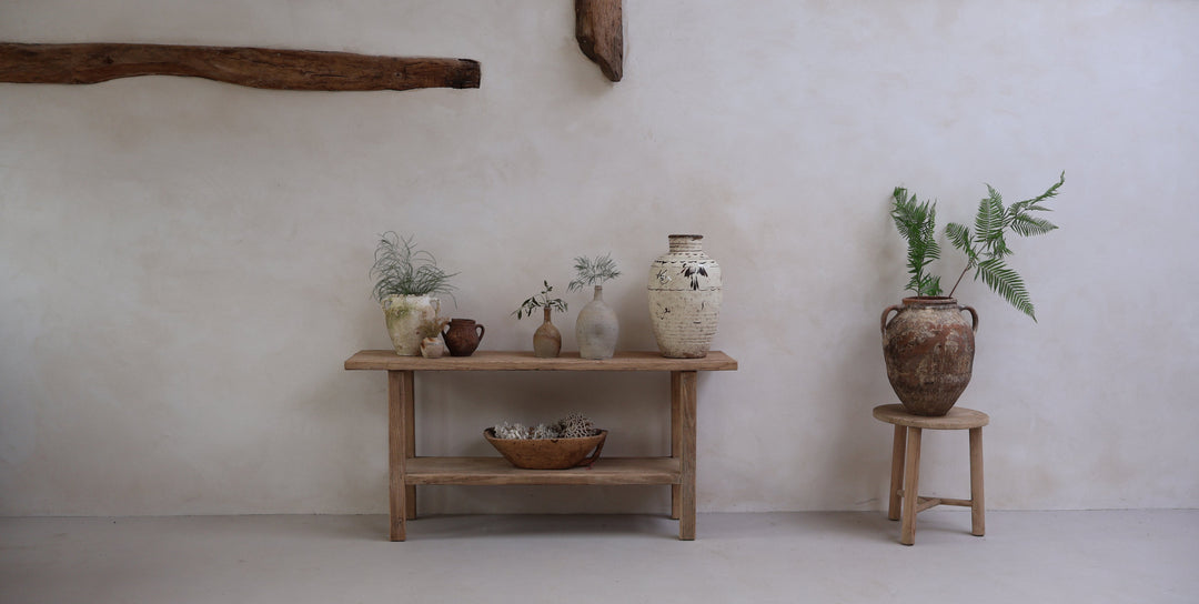 Homebarns collection of modern rustic antique ceramics displayed on an antique console table in a traditional home