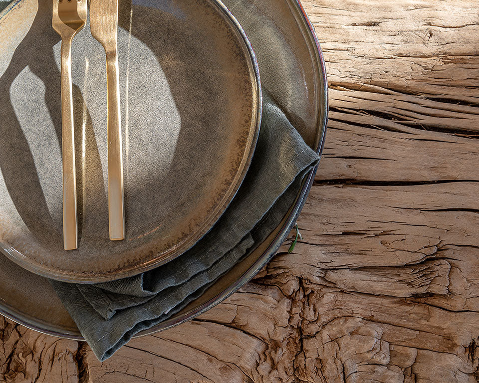Modern rustic ceramics and tableware displayed on a rustic handcrafted salvaged dining table