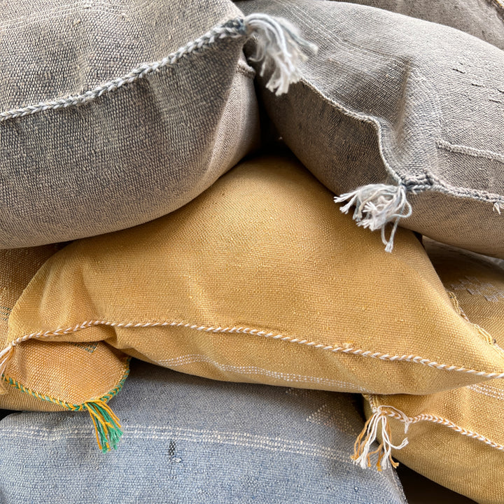 Stack of textured fabric bags in various colors.