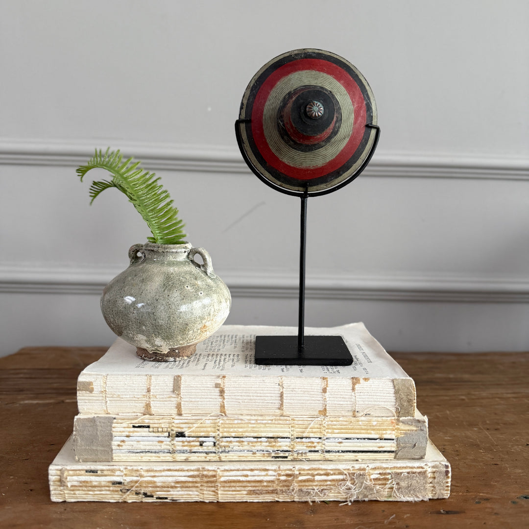 Antique small spinning top on stand