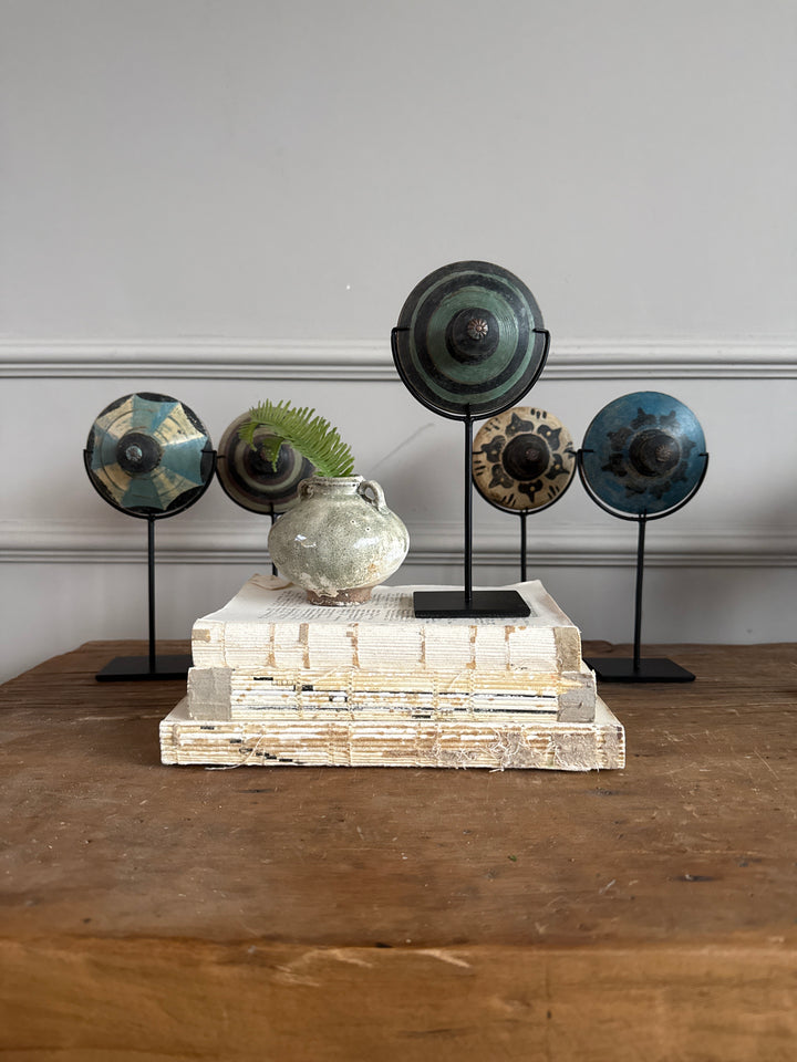 Antique small spinning top on stand