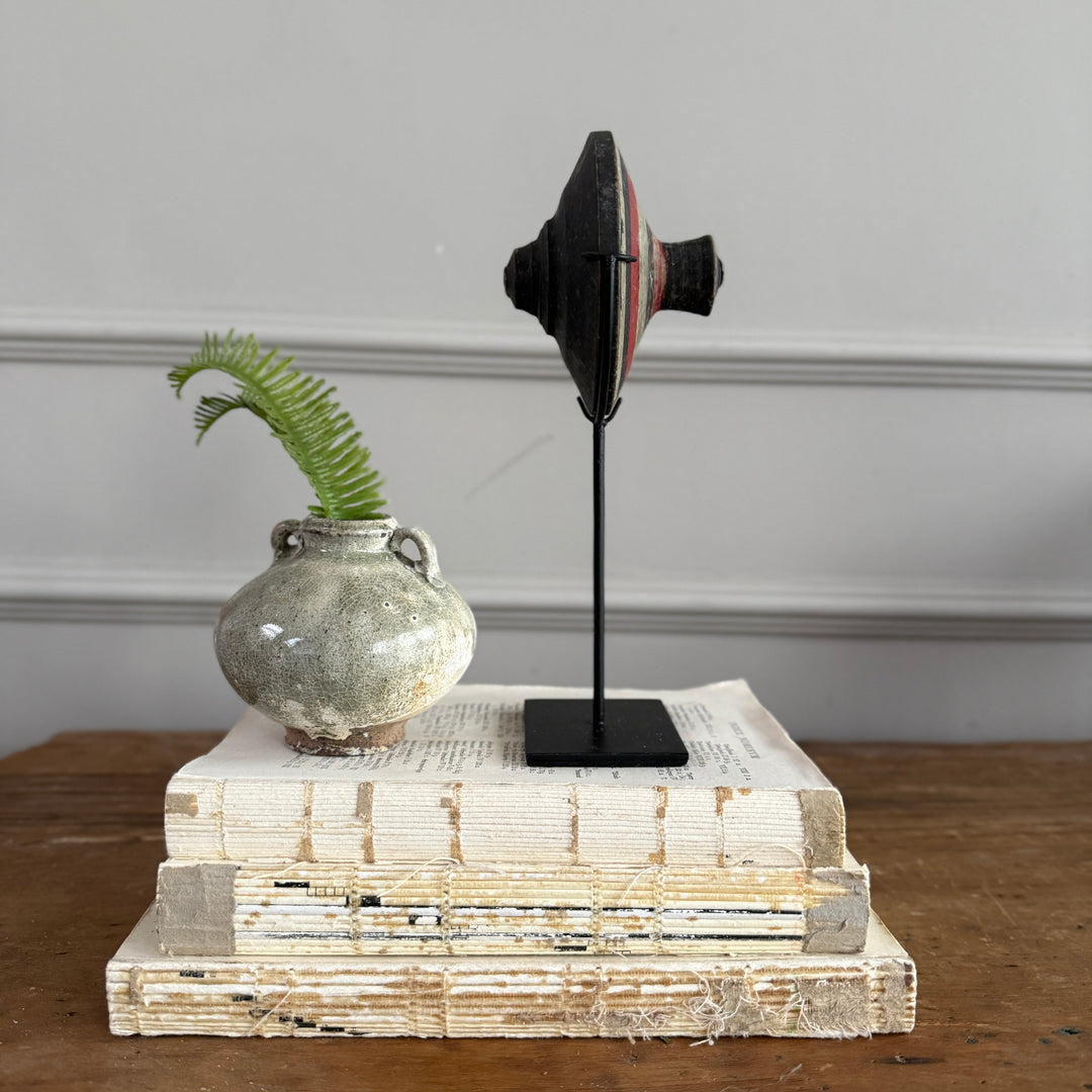 Antique small spinning top on stand