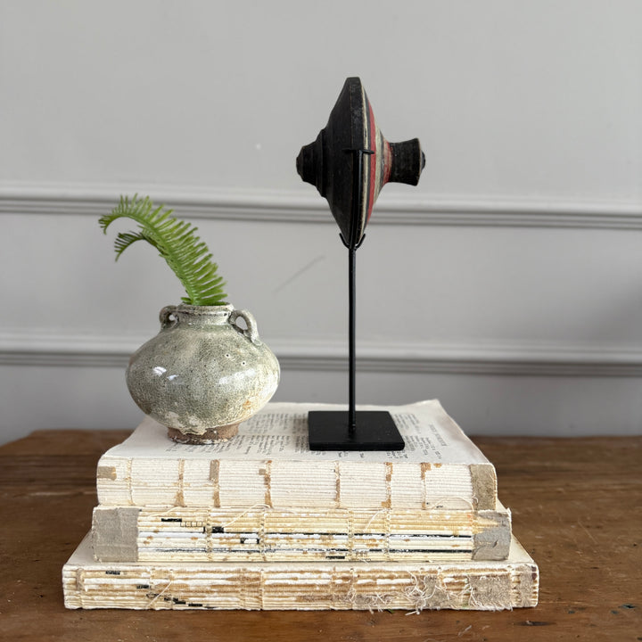 Antique small spinning top on stand