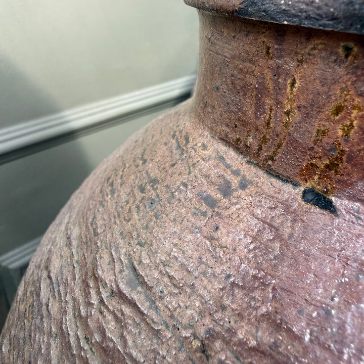 Detail of the neck and shoulder of an antique Chinese stoneware storage jar, revealing its authentic patina and traditional craftsmanship.
