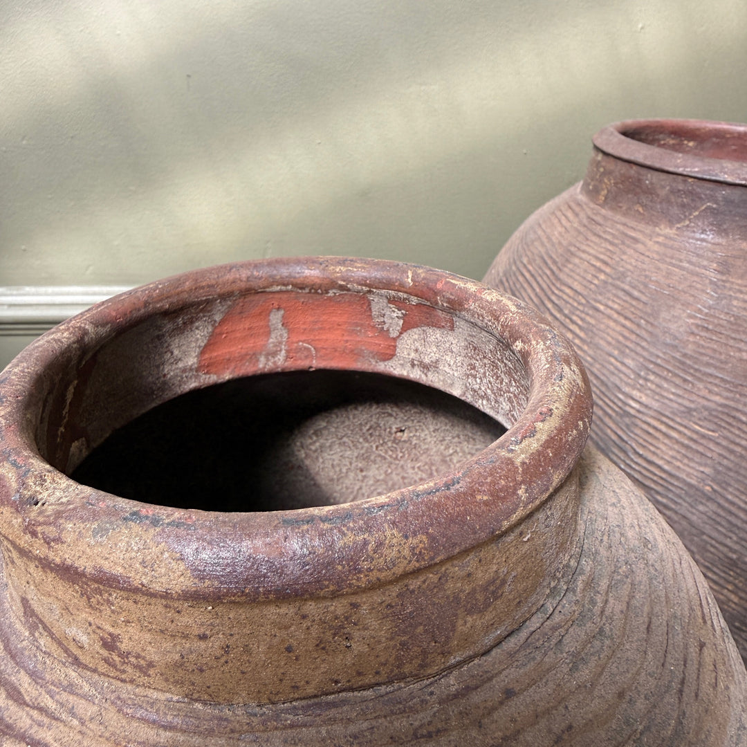 Close-up of the rim and interior of an antique Chinese stoneware storage jar, revealing traditional craftsmanship and authentic age.
