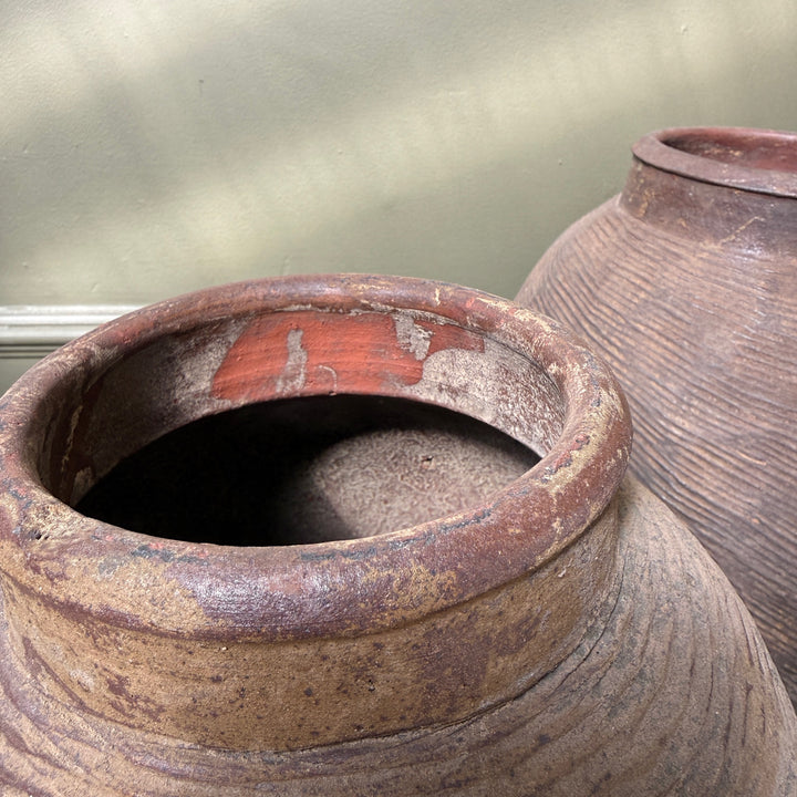 Close-up of the rim and interior of an antique Chinese stoneware storage jar, revealing traditional craftsmanship and authentic age.
