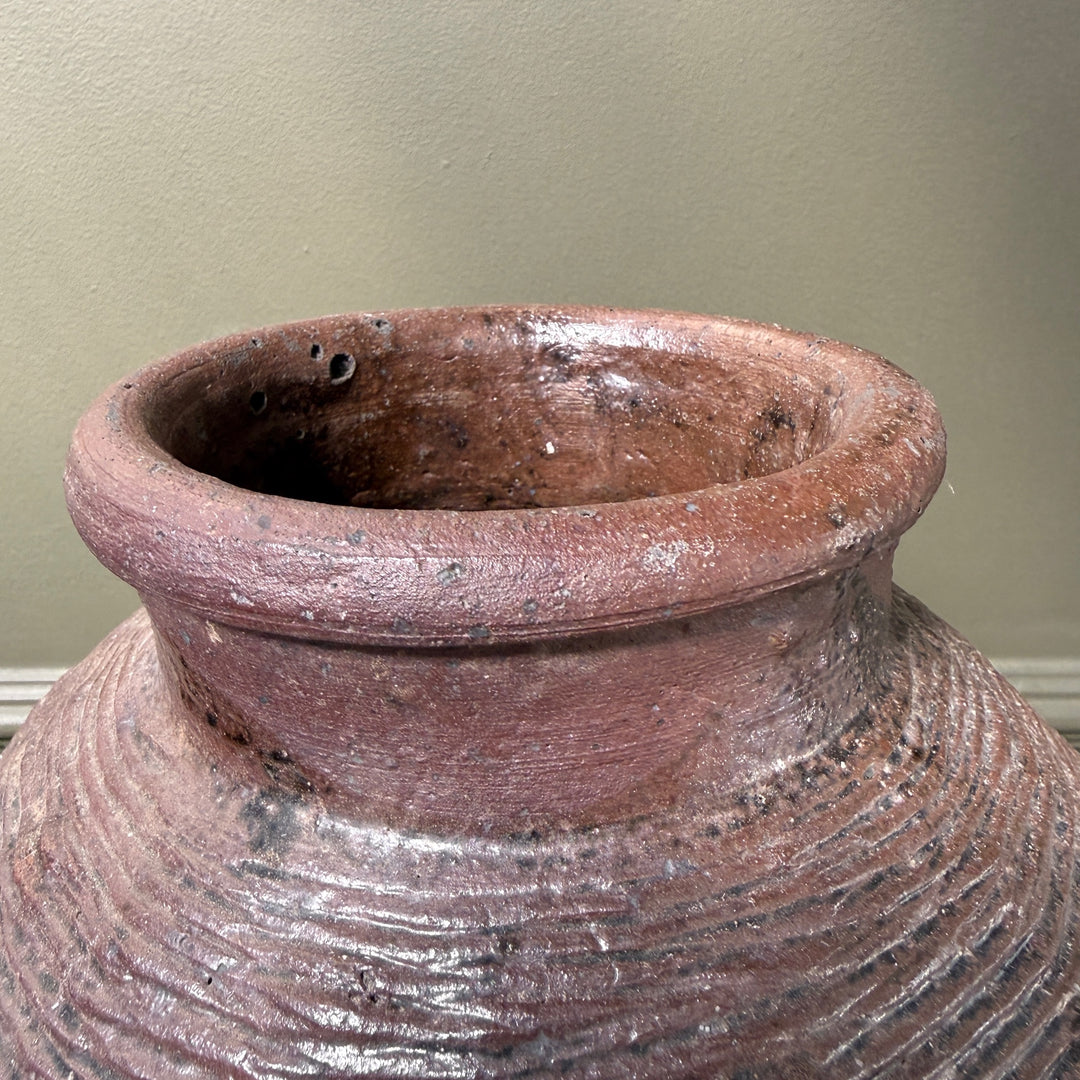 Close-up of the neck and rim of a genuine antique Chinese storage jar, showcasing its weathered character and historic stoneware surface.
