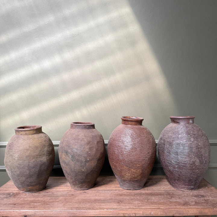 Selection of antique Chinese storage jars with rich earthy tones and traditional hand-combed decoration, each individually unique.
