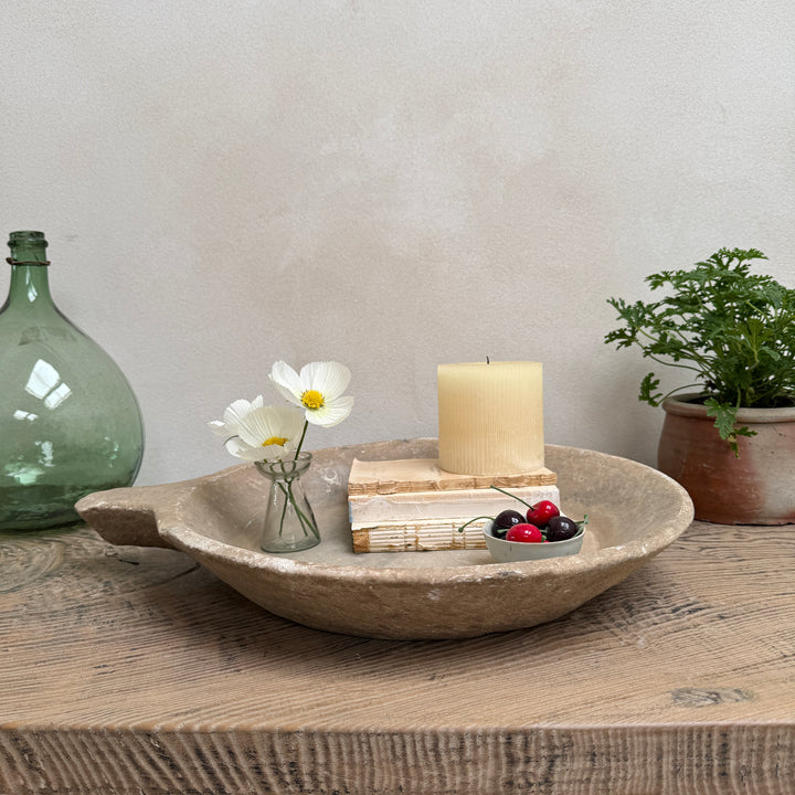 Antique Indian marble bowl hand-carved from solid stone, styled as a decorative centrepiece with candles, books and flowers on a rustic wooden table.