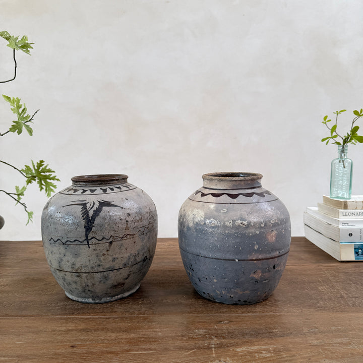 Two authentic Ming Dynasty Chinese pottery storage jars displayed together, showcasing original hand-painted decoration, historic patina and centuries of craftsmanship.

