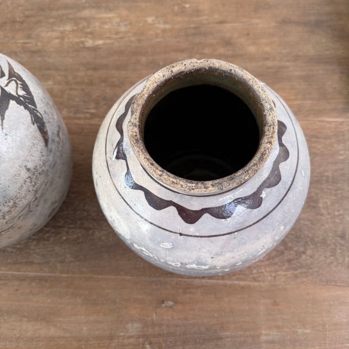 Detail of the hand-painted rim and opening of an authentic Ming Dynasty Chinese pottery storage jar with naturally aged finish.
