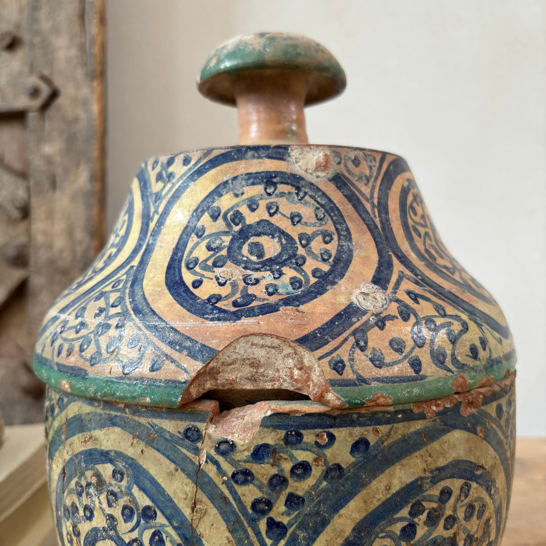Decorative ceramic jar with intricate patterns on a neutral background
