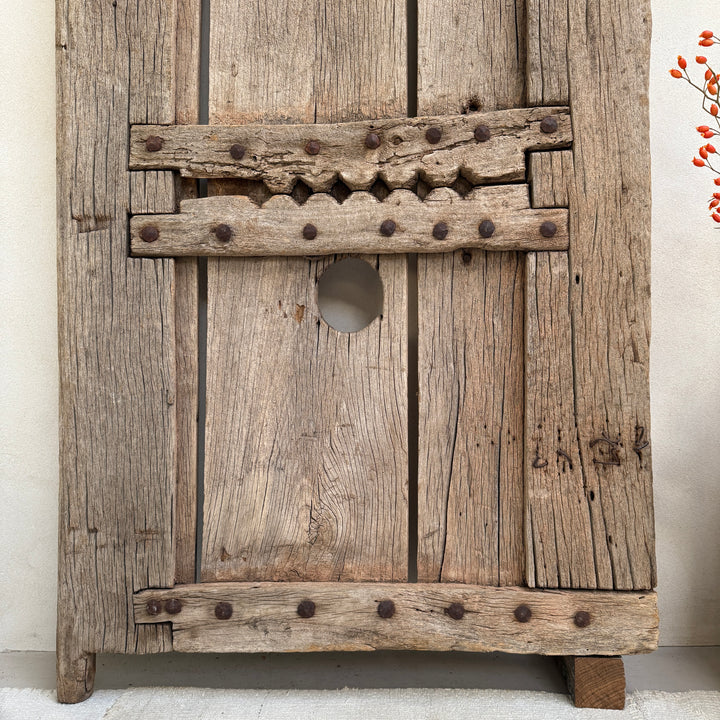 Vintage wooden cabinet with metal accents on a white background