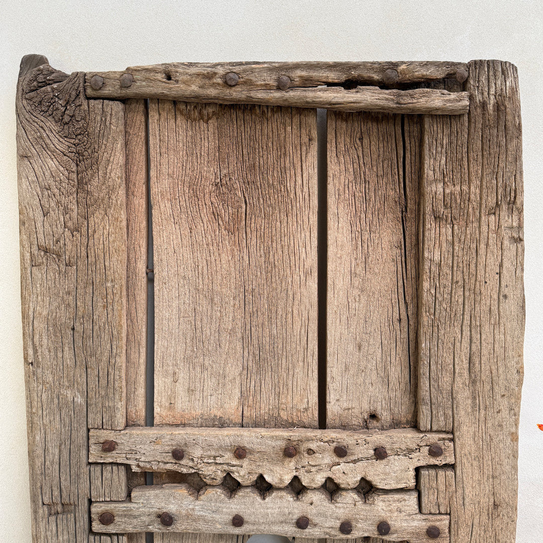Vintage wooden panel with metal reinforcements on a white background