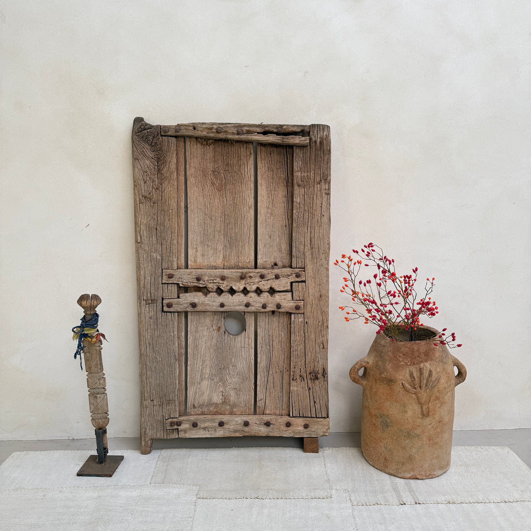 Vintage wooden door with rustic decor elements on a light background