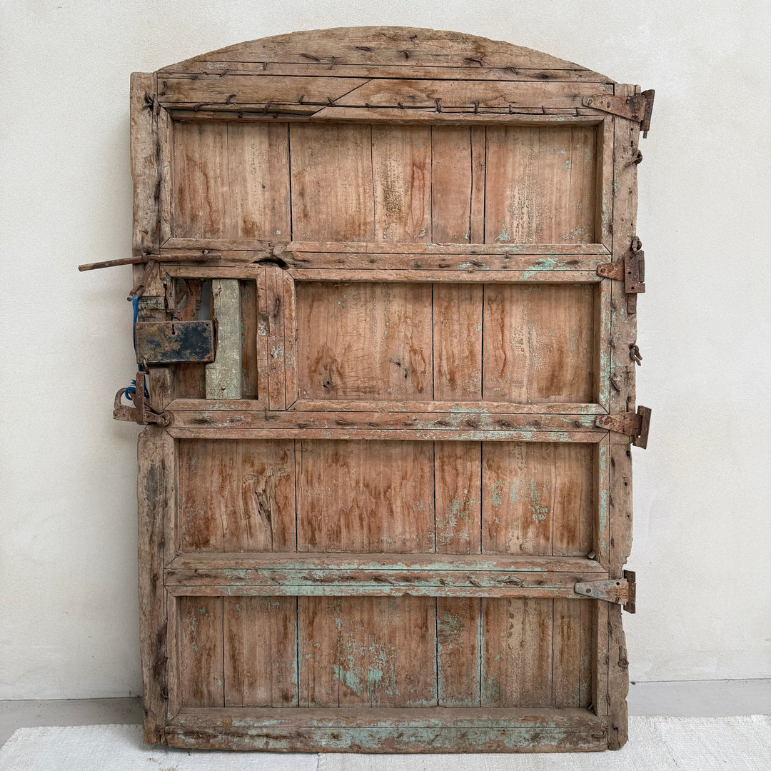Vintage wooden door with a rustic appearance on a plain background