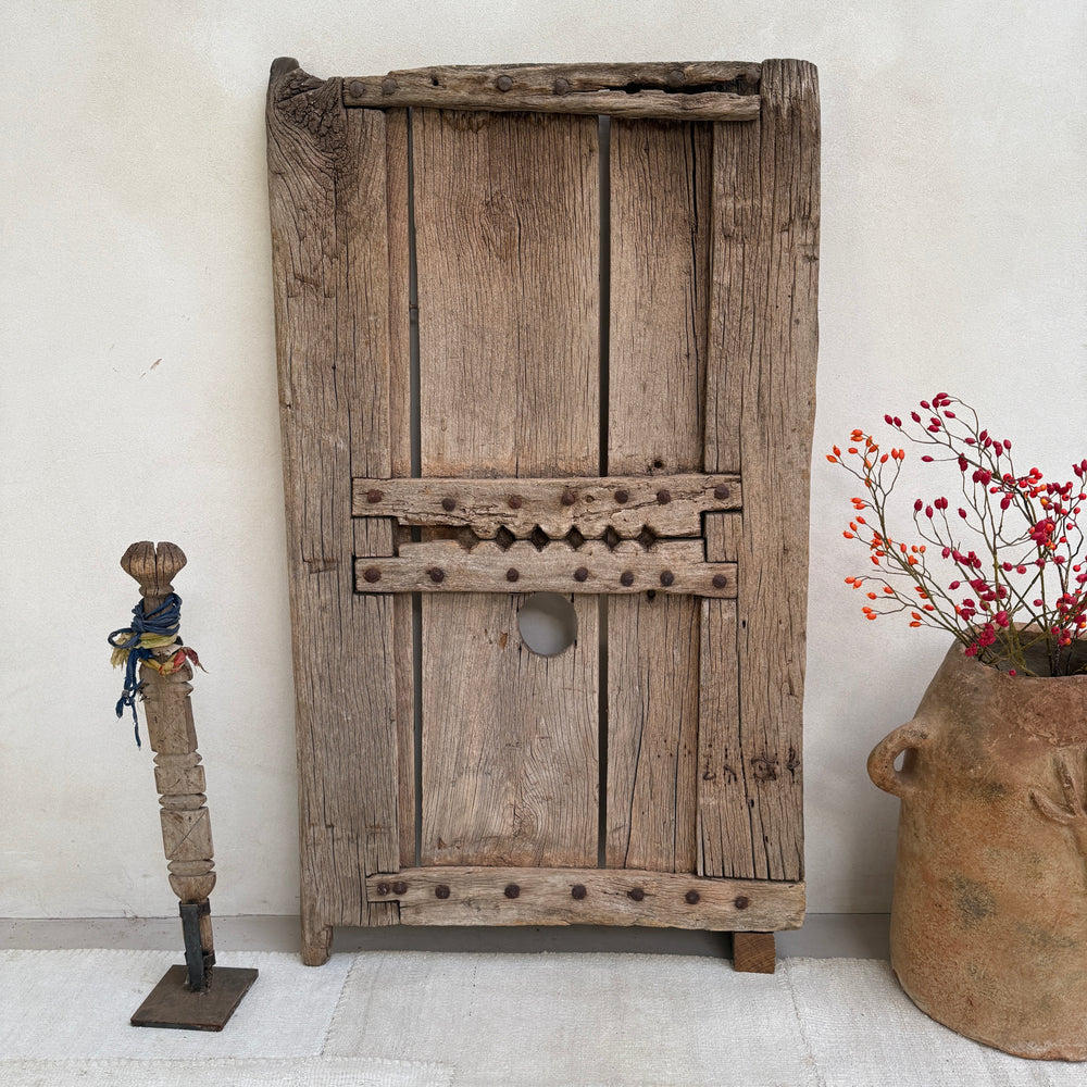 Vintage wooden door with rustic decor elements on a light background