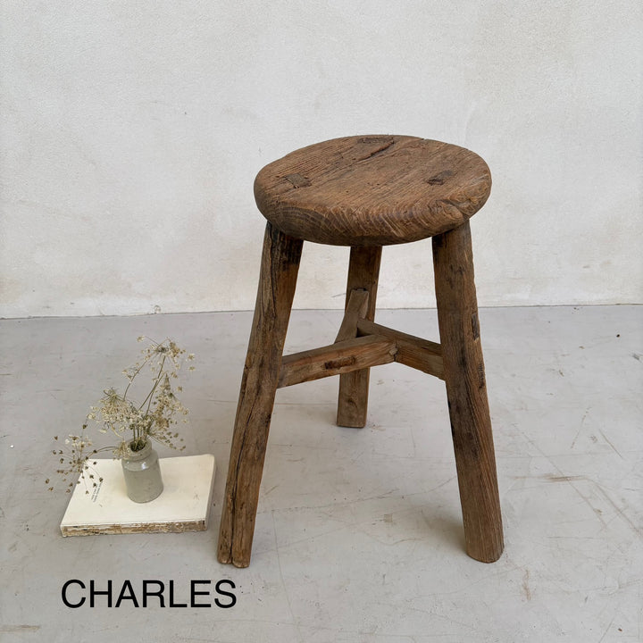 Wooden stool with a white background and 'CHARLES' branding.