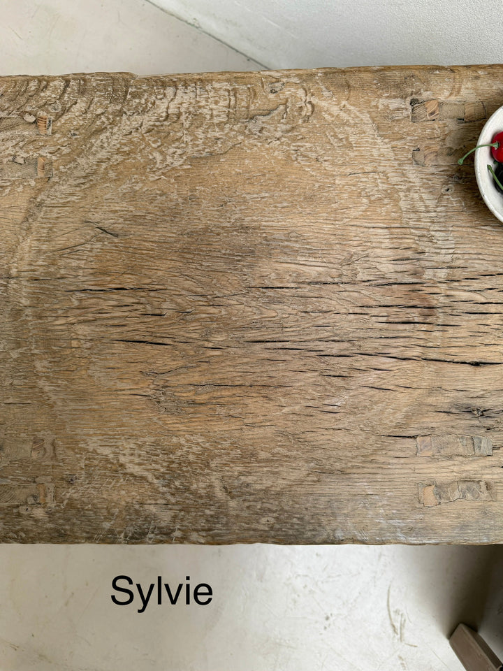 Wooden surface with a textured finish, labeled &