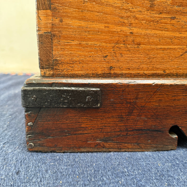 Detail of the shaped plinth base and original iron corner strap on the Antique Victorian Oak Blanket Box.
