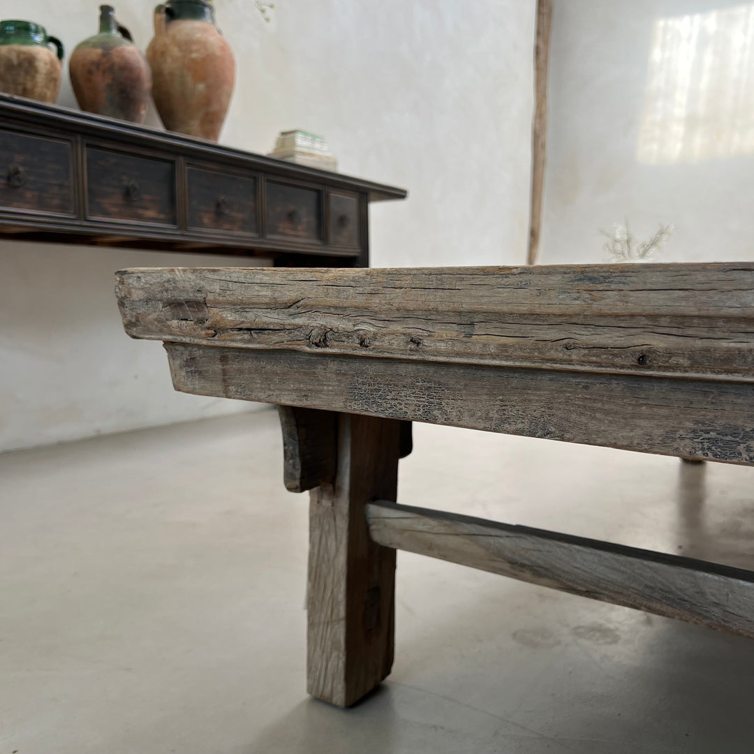 Wooden table with rustic finish in a room setting