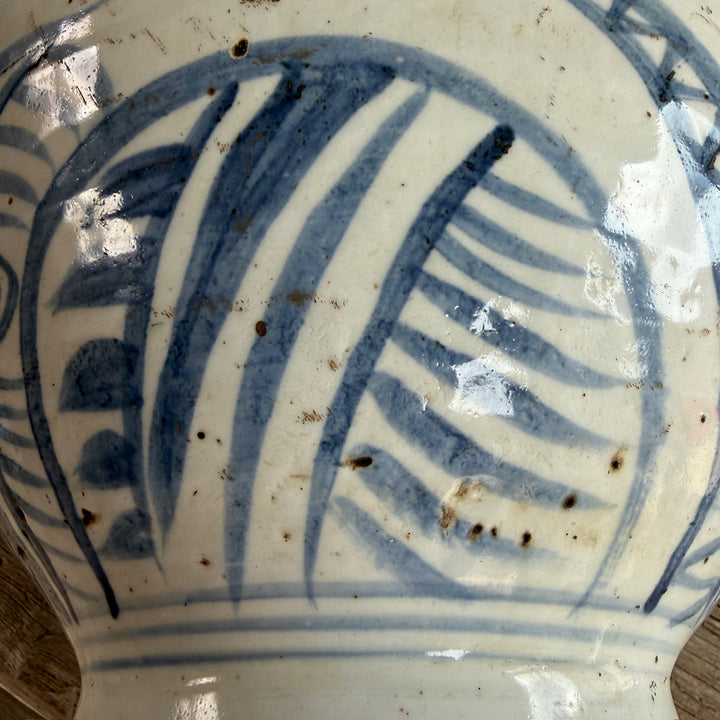Detailed view of the hand-painted blue and white porcelain vase highlighting the rich glaze, painted botanical motifs and handcrafted finish.
