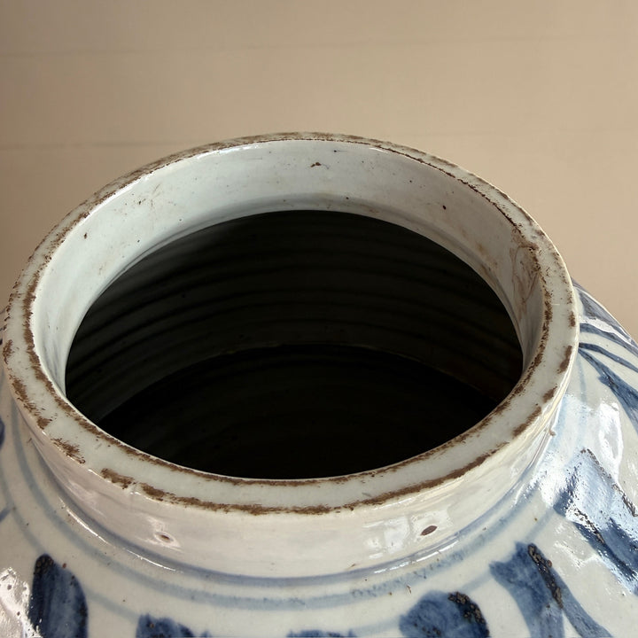Close-up of the interior opening of the hand-painted blue and white porcelain vase, revealing its handcrafted porcelain construction.
