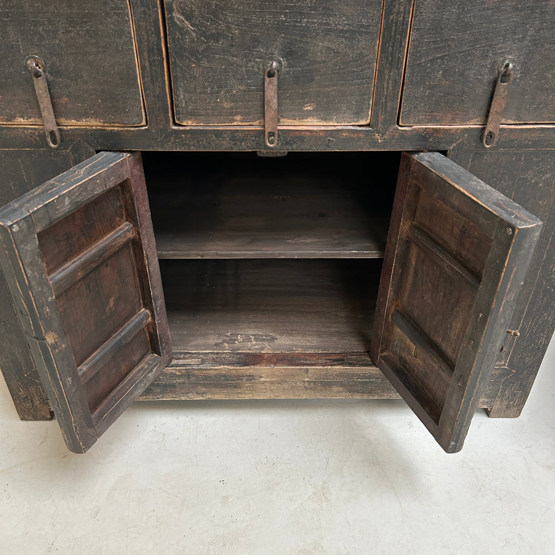 Wooden cabinet with open doors on a light gray background