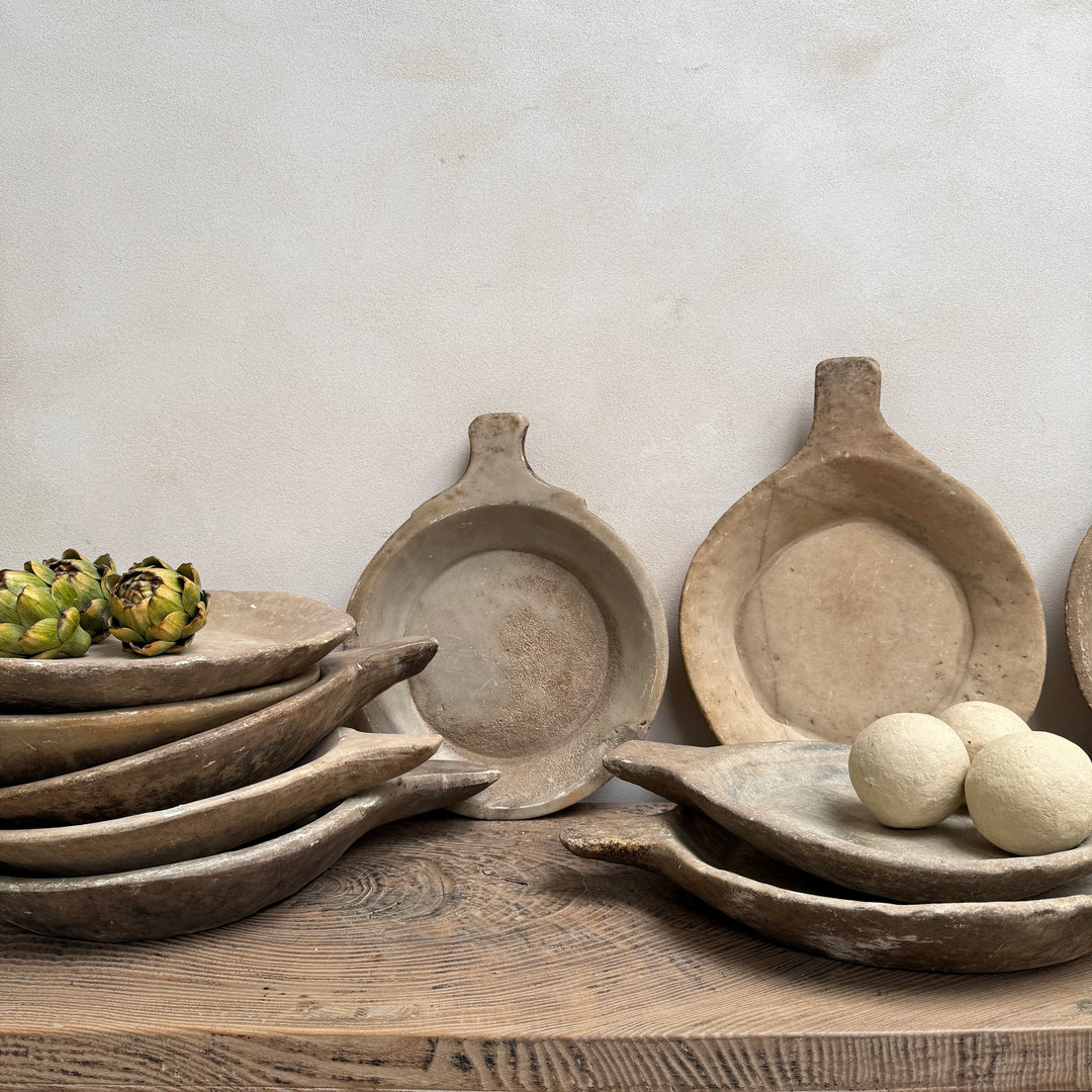 Collection of antique Indian marble bowls hand carved from natural stone, displayed together as decorative rustic home accessories.