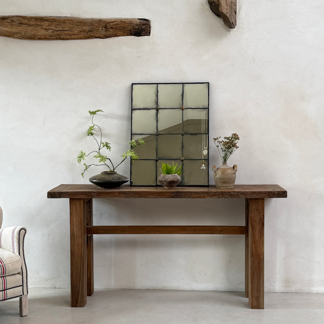 Cosima antique style window mirror with beautifully distressed mirror glass displayed on a reclaimed wood console table in a luxury country home.