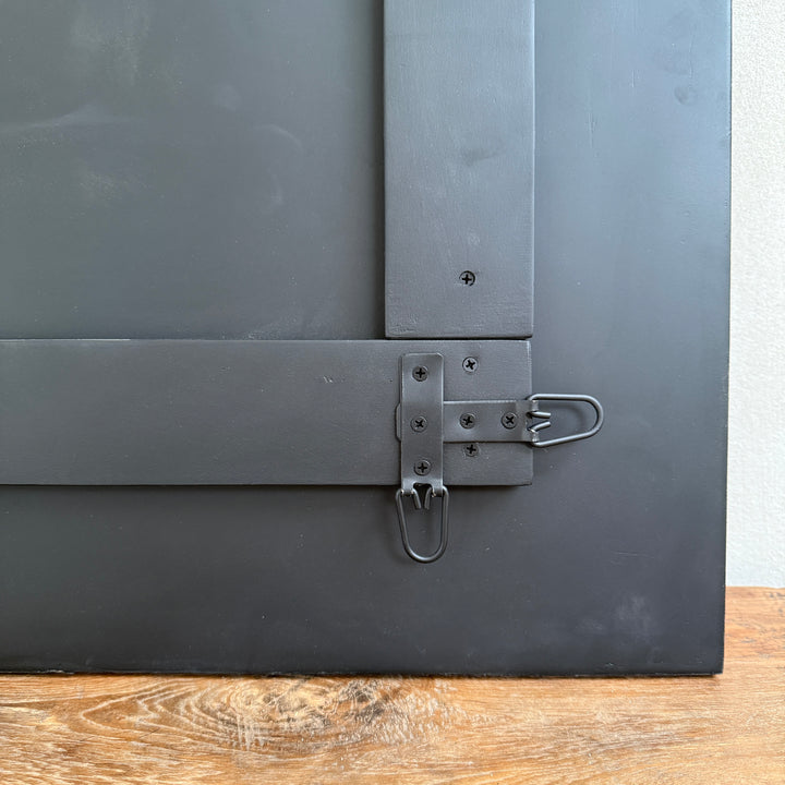Rear view of the Cosima foxed antiqued mirror showing the timber backing and integrated fixings for portrait or landscape wall mounting.