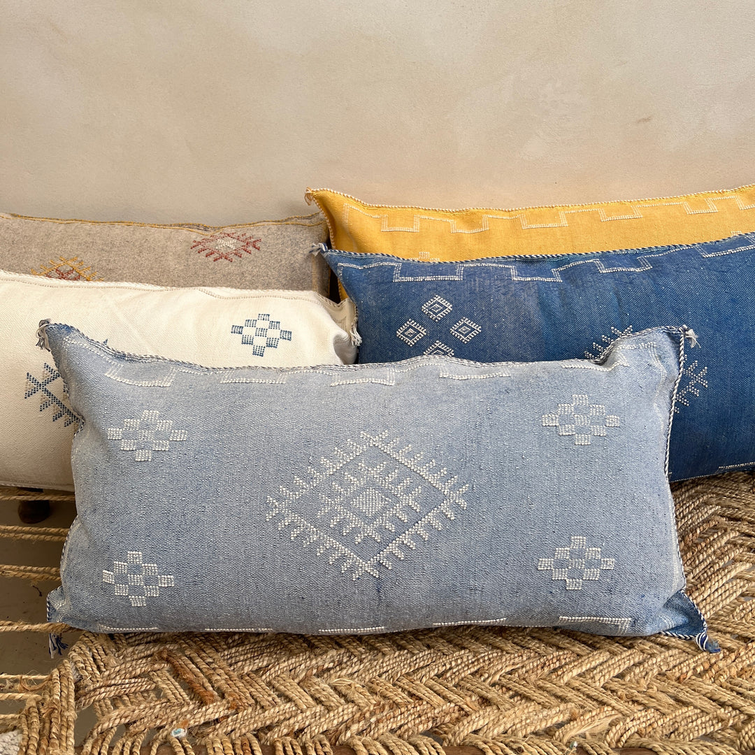 Set of decorative pillows with geometric patterns on a textured surface