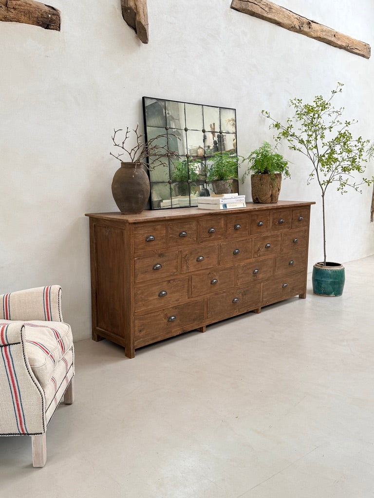 side view or large dark wood apothcary drawers