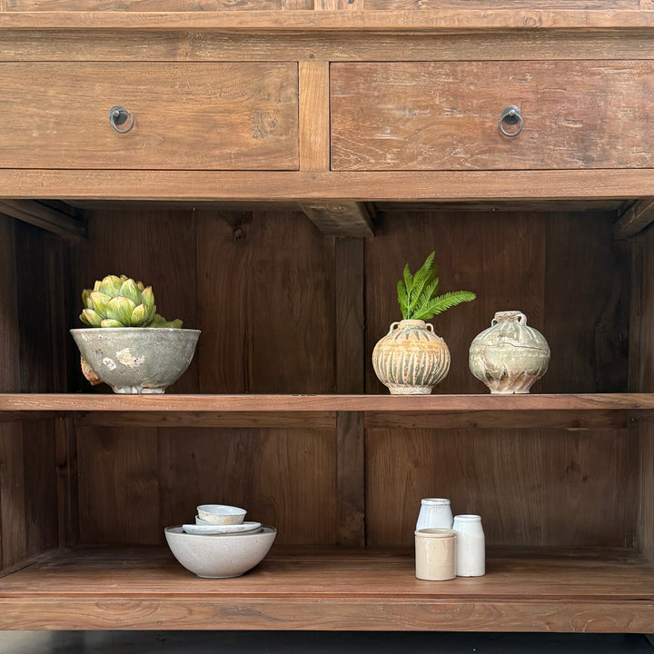 nterior shelving of the Eton reclaimed teak display cabinet showing spacious solid wood storage for ceramics, glassware and decorative accessories.