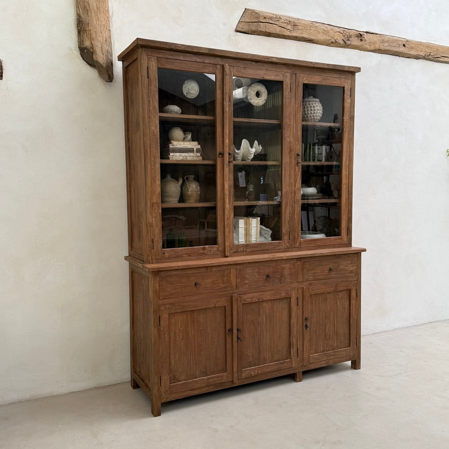 Angled view of the Eton reclaimed teak glazed display cabinet highlighting its generous storage and timeless dark wood finish.