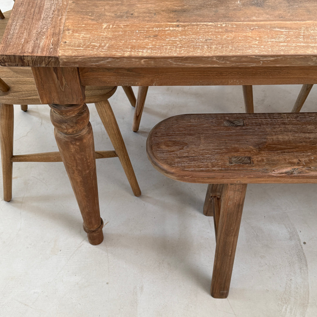 The extending teak dining table shown from above illustrating the turned table le