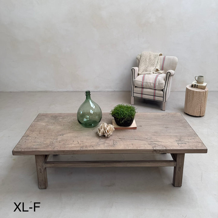 Wooden coffee table with decorative items in a minimalistic room.