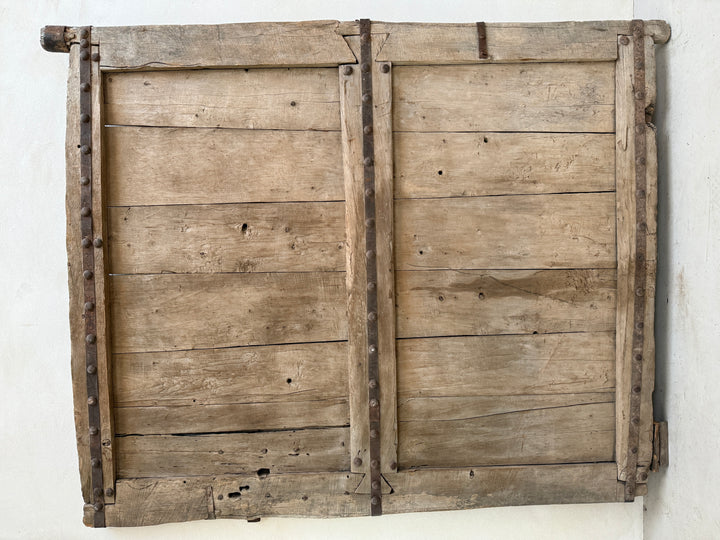 Pair of wooden shutters on a white wall