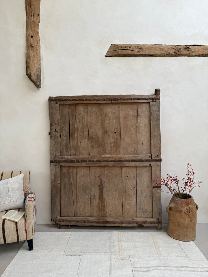 Wooden shutter on a white wall with decorative elements