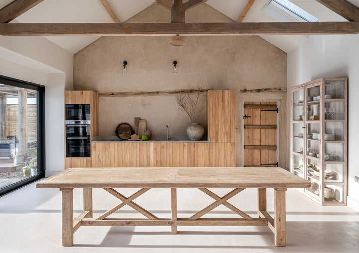 Extra large reclaimed pine dining table with mixed seating in a characterful country dining room