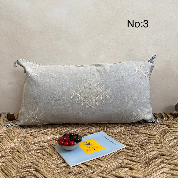Decorative pillow with geometric pattern on a textured surface