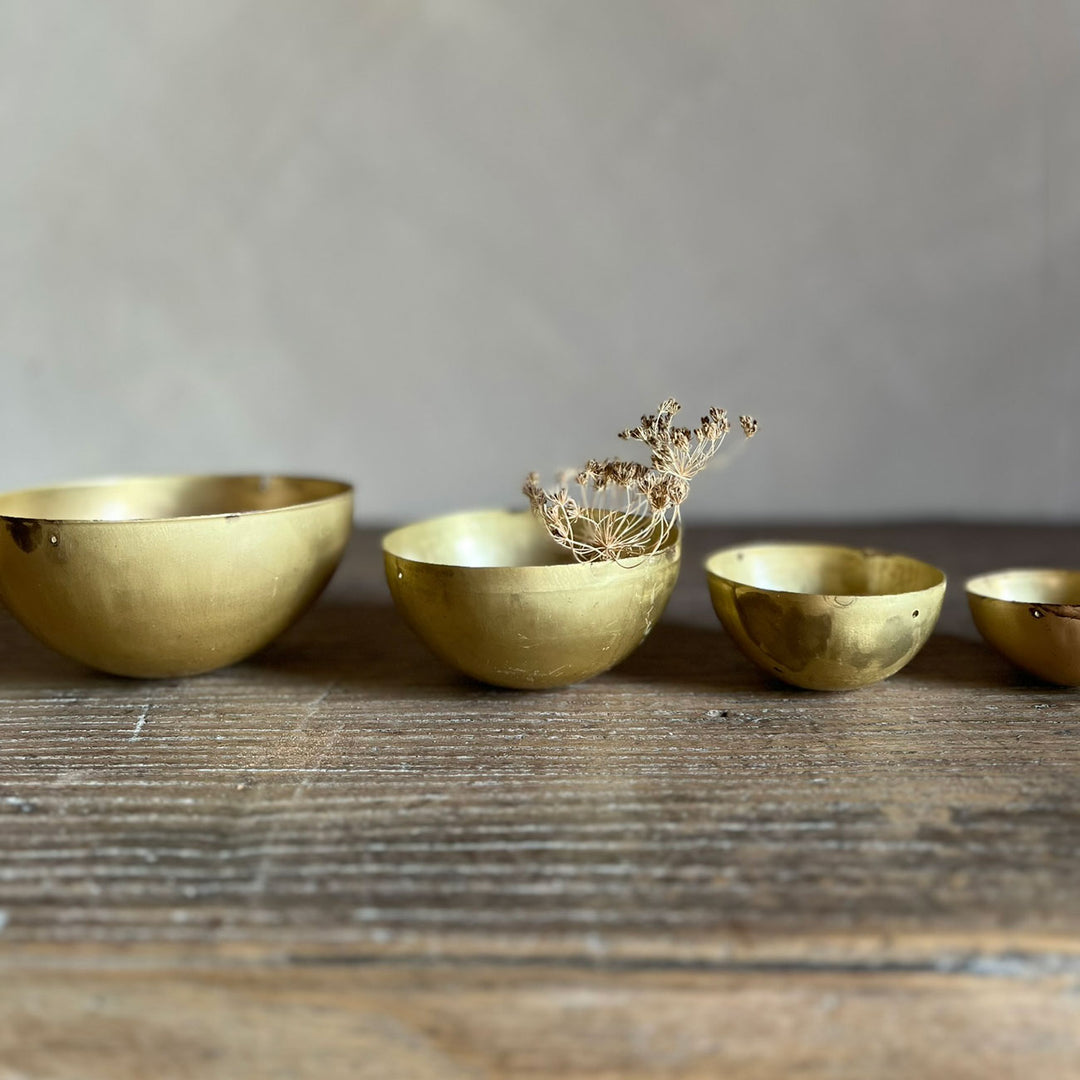 Set of eight gold metal bowls