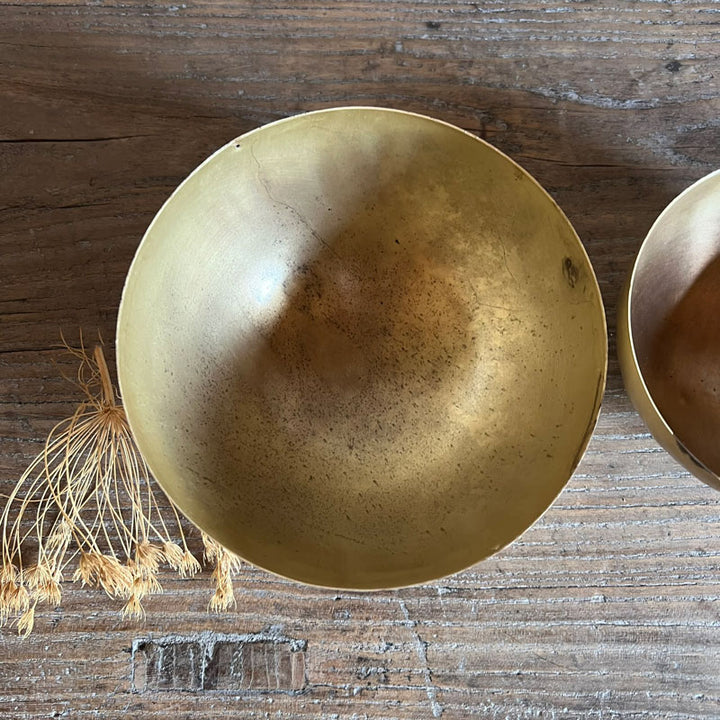 Set of eight gold metal bowls