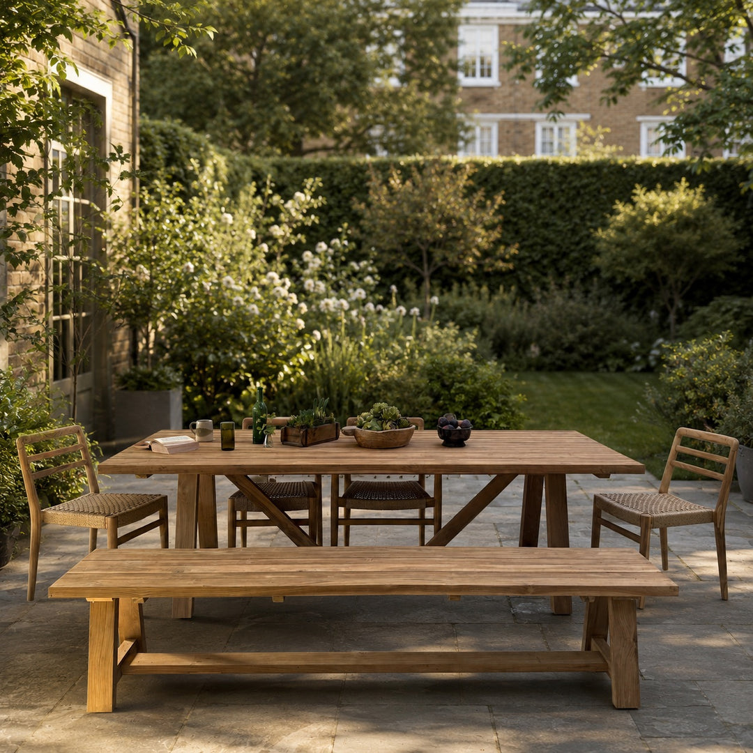 Wooden outdoor dining set with table and chairs in a garden setting.