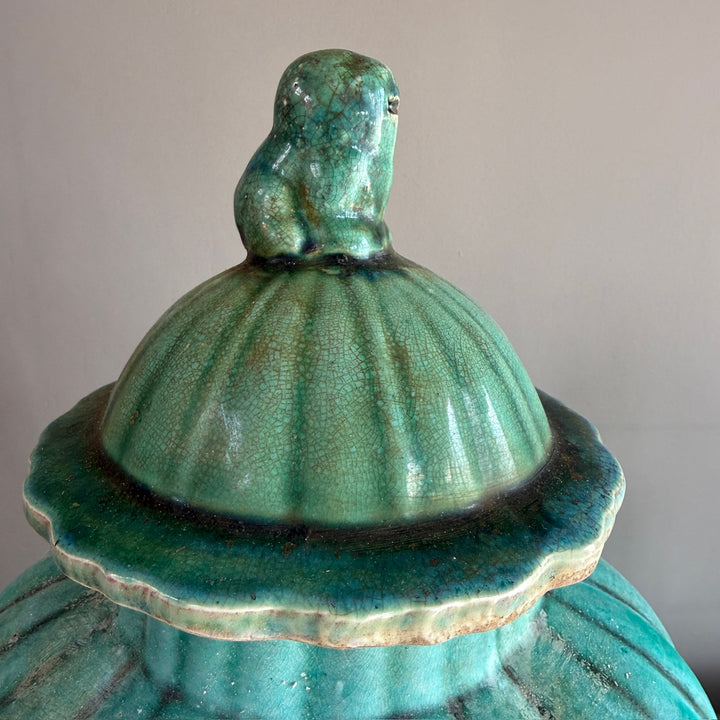 Decorative bird finial on the lid of a green glazed stoneware temple jar, inspired by traditional Chinese ceramic design.
