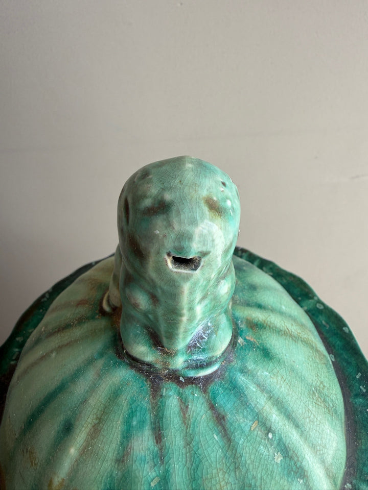 Close-up of the handcrafted bird finial on a green glazed stoneware temple jar, finished with a rich crackle glaze inspired by traditional Chinese ceramics.
